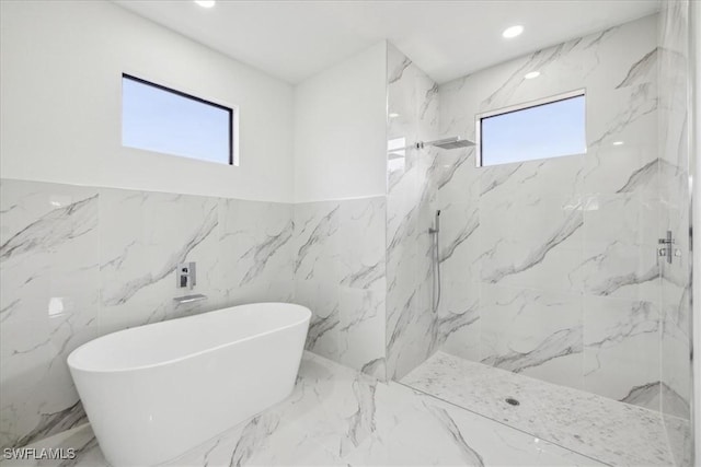1436 Graham Cir, Lehigh Acres, FL 33936 - full bath with a freestanding tub, a healthy amount of sunlight, marble finish floor, and a marble finish shower