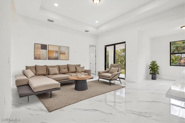 1436 Graham Cir, Lehigh Acres, FL 33936 - living area with visible vents, a wealth of natural light, marble finish floor, and a tray ceiling