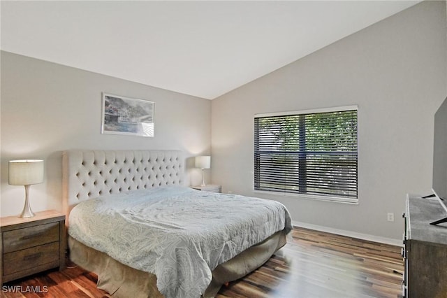 bedroom with lofted ceiling and hardwood / wood-style flooring