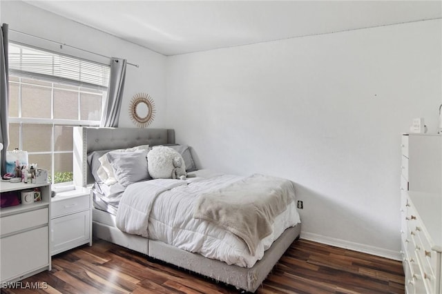 bedroom with dark wood-type flooring