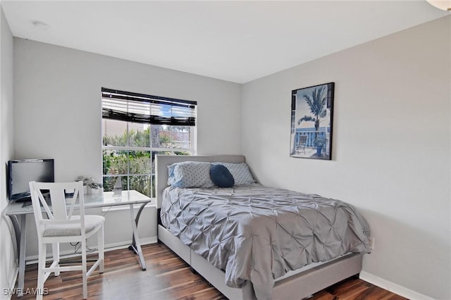 bedroom with dark hardwood / wood-style flooring