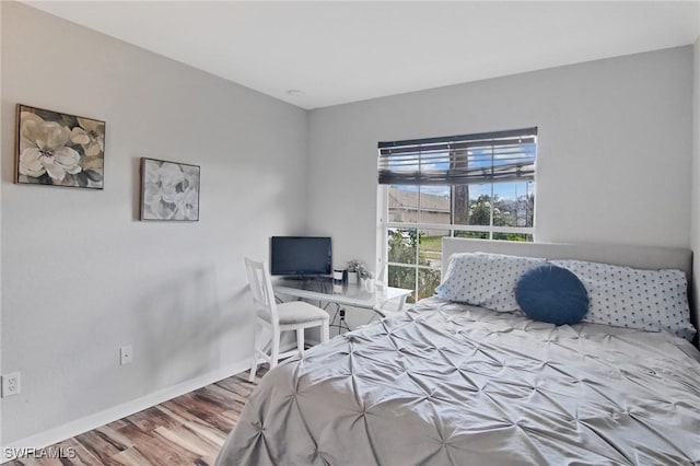 bedroom with hardwood / wood-style flooring