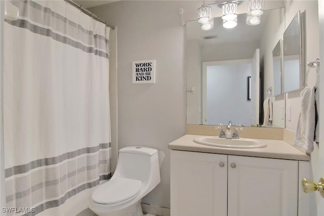 bathroom with vanity, curtained shower, and toilet