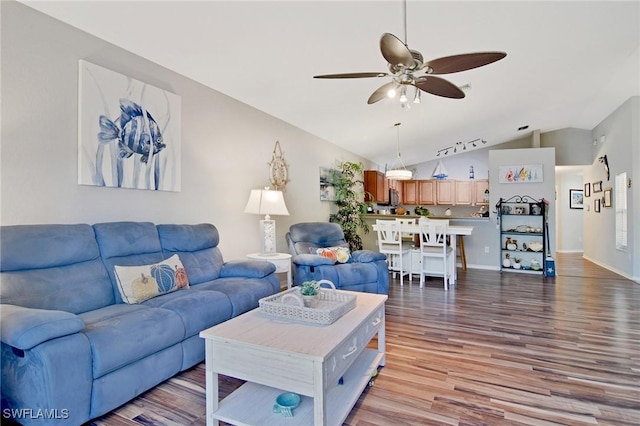 living room with ceiling fan, light wood-type flooring, and vaulted ceiling