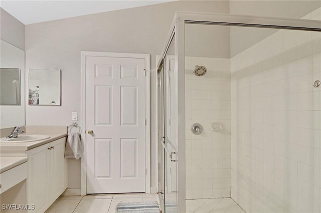 bathroom with tile patterned floors, vanity, and walk in shower