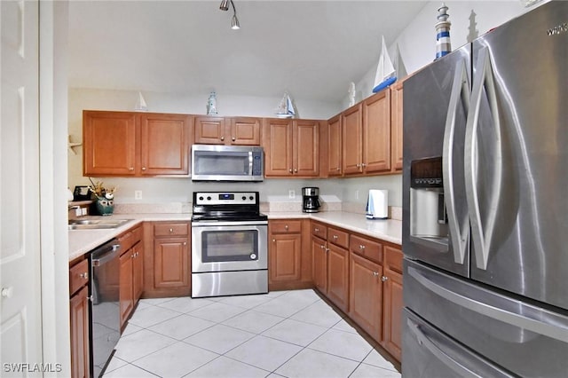 kitchen featuring sink, stainless steel appliances, and light tile patterned flooring