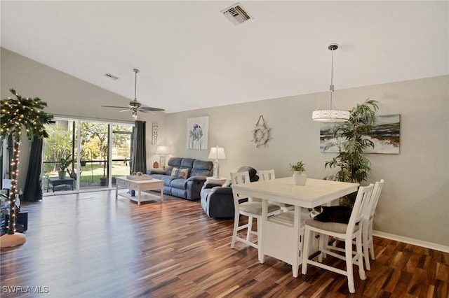 dining room with ceiling fan, dark hardwood / wood-style flooring, and lofted ceiling