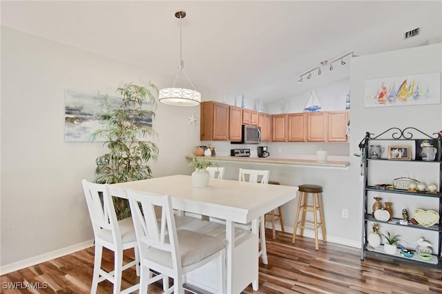 dining room with lofted ceiling and hardwood / wood-style flooring