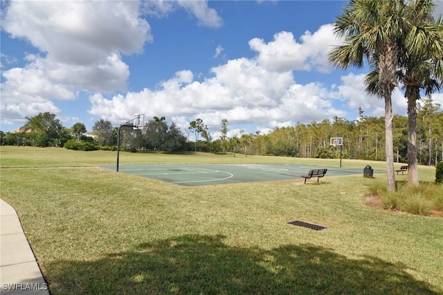 view of sport court with a lawn