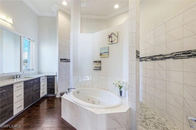 bathroom featuring plus walk in shower, hardwood / wood-style floors, vanity, and crown molding