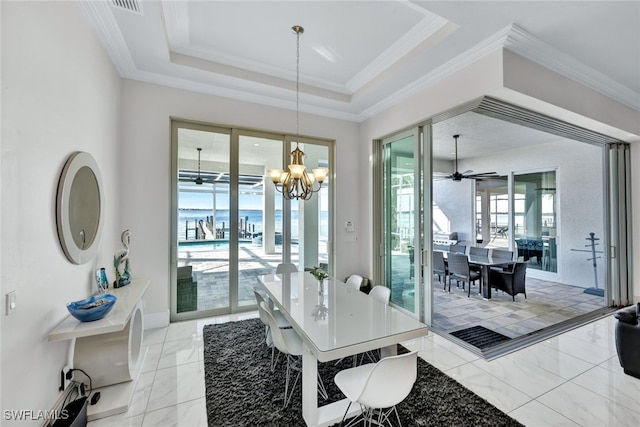 dining space featuring ceiling fan with notable chandelier, crown molding, a tray ceiling, and french doors