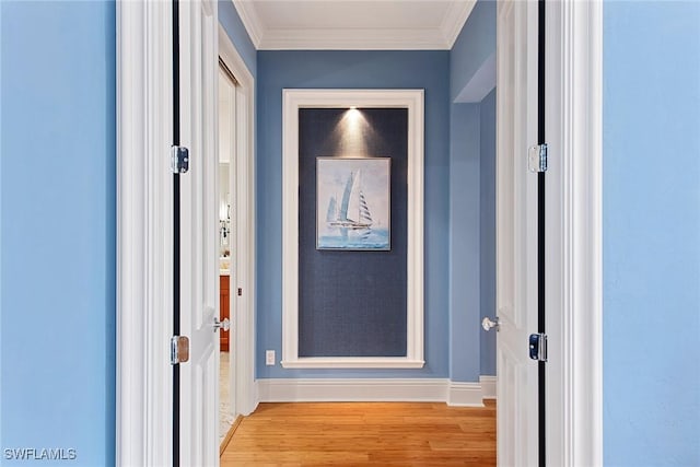 interior space featuring light wood-type flooring and ornamental molding