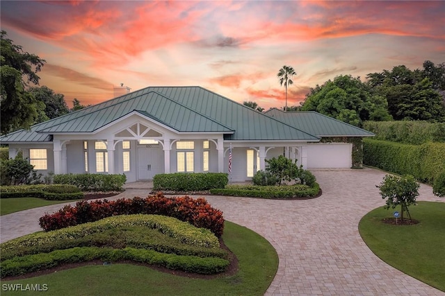 view of front of property with a garage and a yard