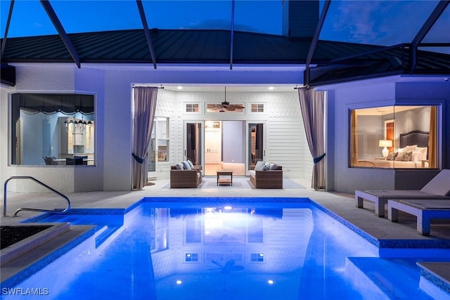 view of pool featuring glass enclosure, ceiling fan, and a patio area