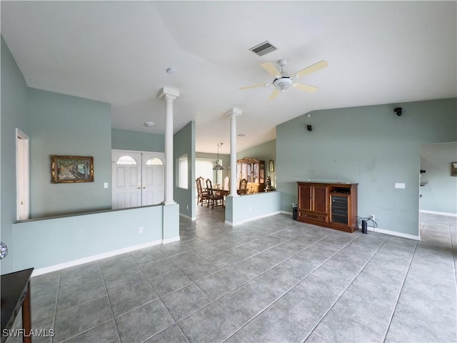 unfurnished living room with tile patterned flooring, ceiling fan with notable chandelier, and lofted ceiling