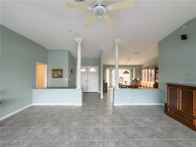 unfurnished living room featuring light tile patterned floors, ornate columns, and ceiling fan