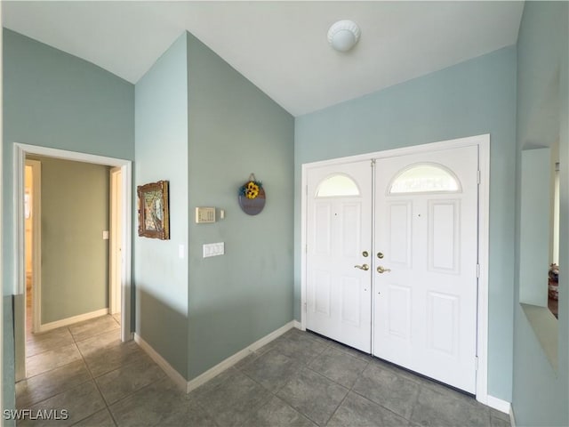 foyer entrance featuring dark tile patterned floors