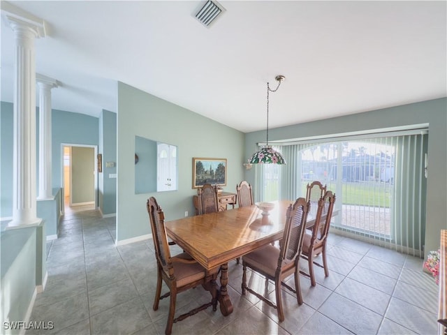 dining room with vaulted ceiling, light tile patterned flooring, and decorative columns