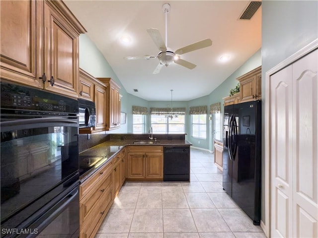 kitchen with light tile patterned floors, sink, lofted ceiling, and black appliances