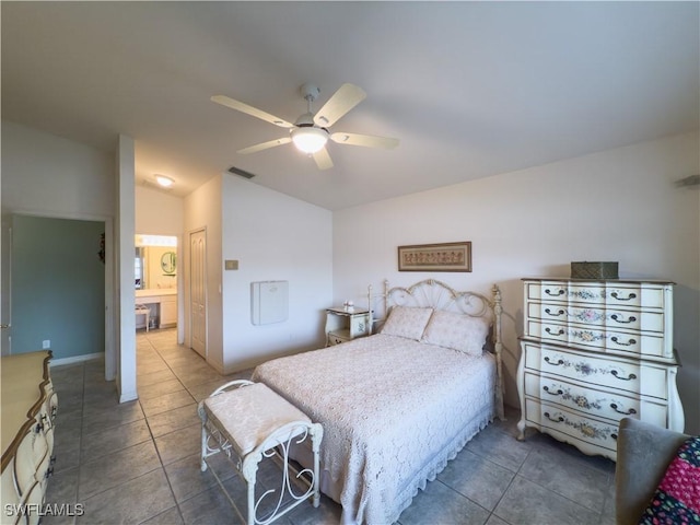 tiled bedroom with connected bathroom, ceiling fan, and a closet