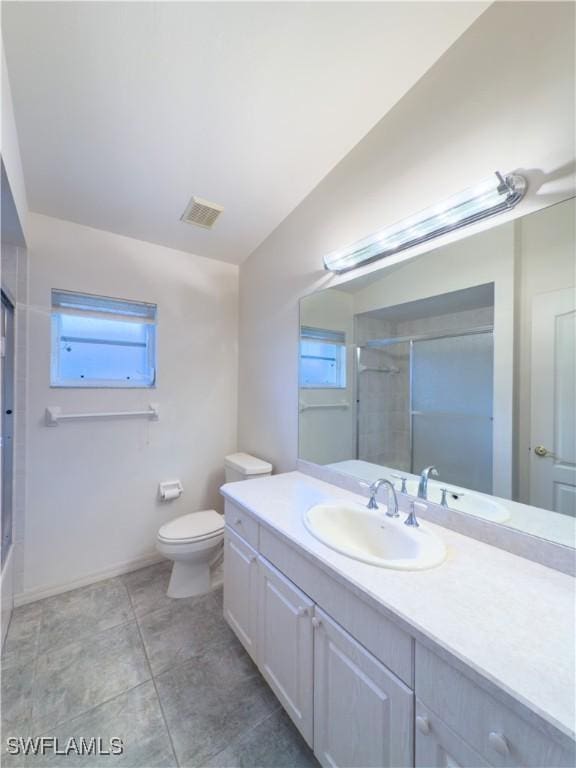 full bathroom featuring enclosed tub / shower combo, vanity, a healthy amount of sunlight, and toilet