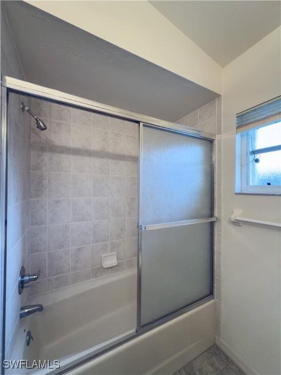 bathroom featuring shower / bath combination with glass door