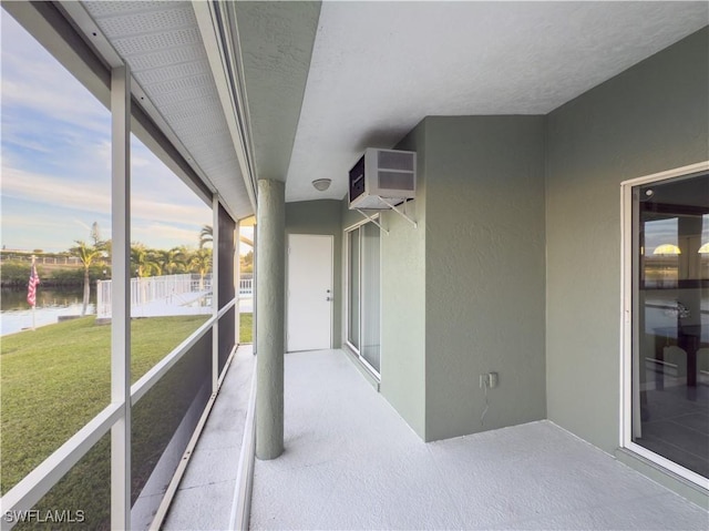 unfurnished sunroom featuring a water view