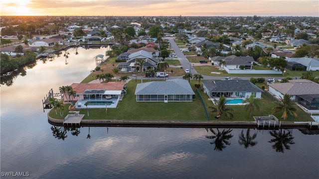 aerial view at dusk with a water view