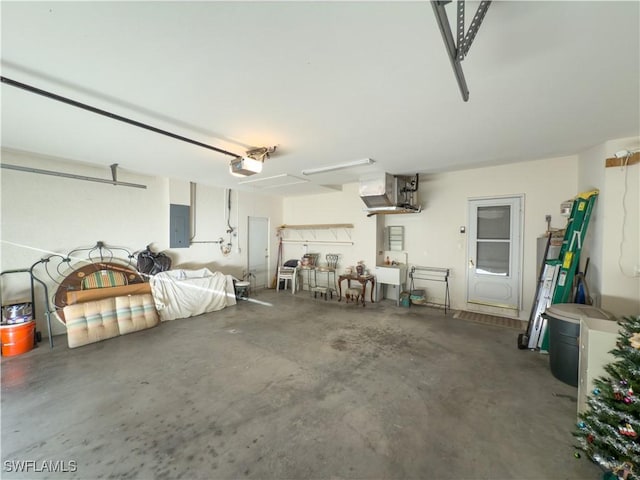 garage featuring electric panel and a garage door opener