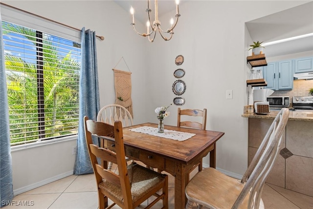 tiled dining space featuring plenty of natural light and a chandelier