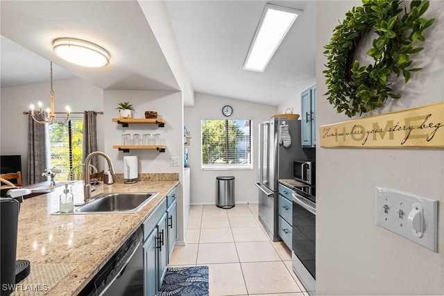 kitchen with sink, vaulted ceiling, appliances with stainless steel finishes, light tile patterned flooring, and a chandelier