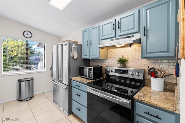 kitchen with light tile patterned floors, stainless steel appliances, blue cabinets, and lofted ceiling