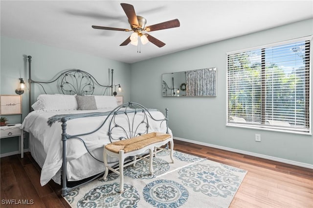 bedroom with hardwood / wood-style floors and ceiling fan