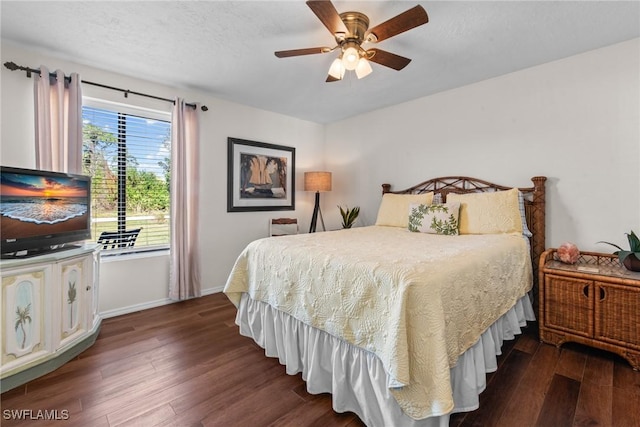 bedroom featuring a textured ceiling, dark hardwood / wood-style floors, and ceiling fan