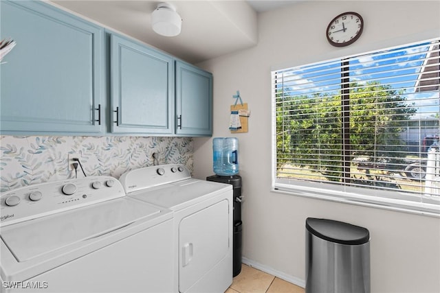 laundry area featuring cabinets, independent washer and dryer, and light tile patterned floors