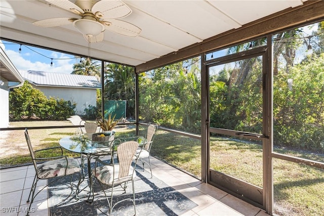 unfurnished sunroom with ceiling fan