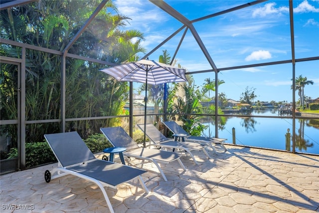 view of patio / terrace with a water view and glass enclosure