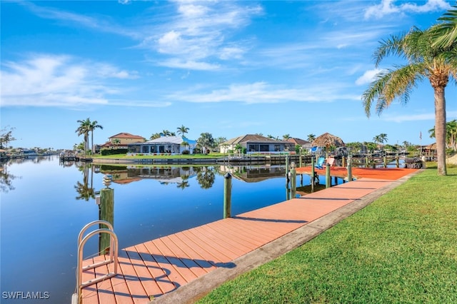 view of dock featuring a water view and a yard