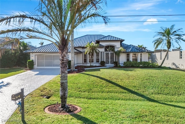 view of front of property with a garage and a front yard