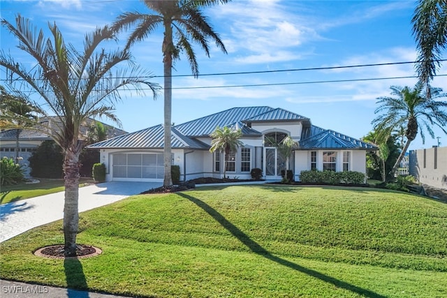 view of front of house with a garage and a front lawn