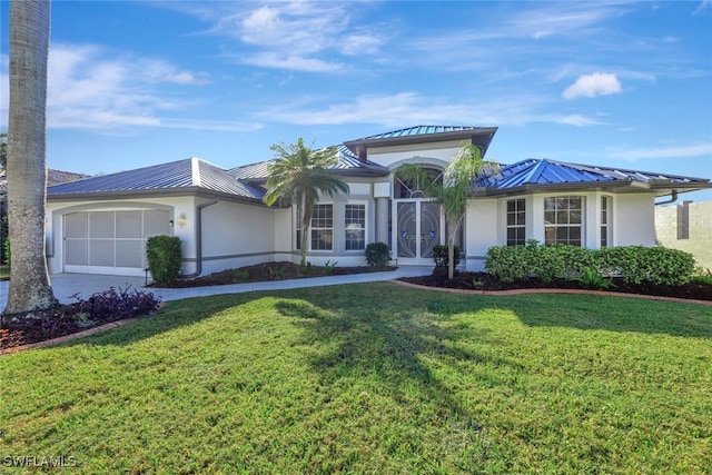 view of front of home featuring a garage and a front lawn