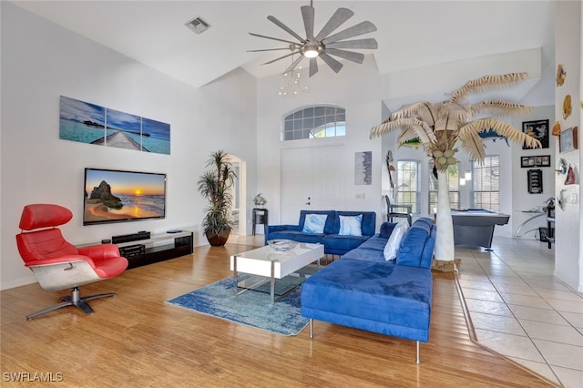 living room featuring hardwood / wood-style floors, pool table, and a high ceiling