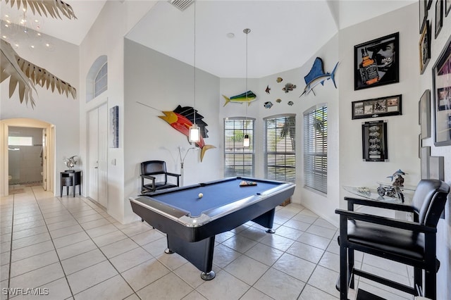 playroom featuring light tile patterned floors, pool table, and a high ceiling