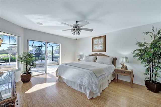 bedroom with ceiling fan, access to exterior, and light wood-type flooring