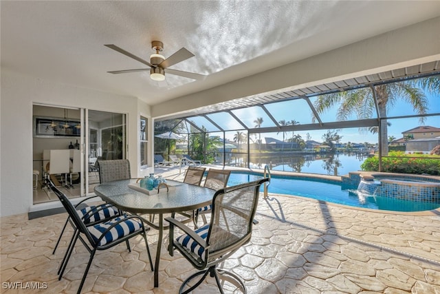 view of swimming pool featuring a lanai, ceiling fan, a patio, a water view, and an in ground hot tub