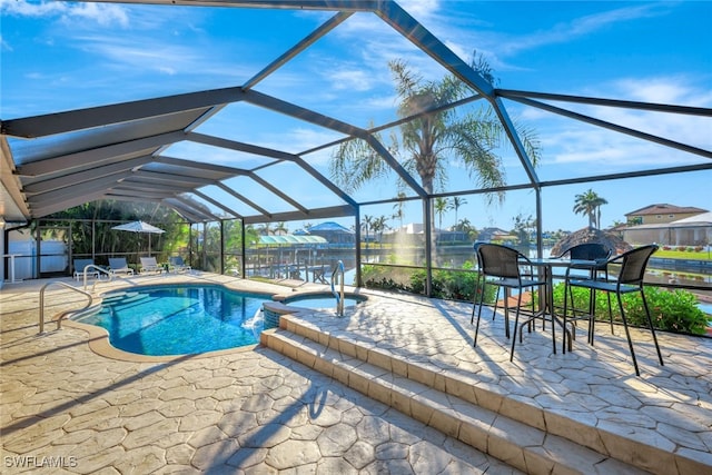 view of pool featuring an in ground hot tub, glass enclosure, and a patio area