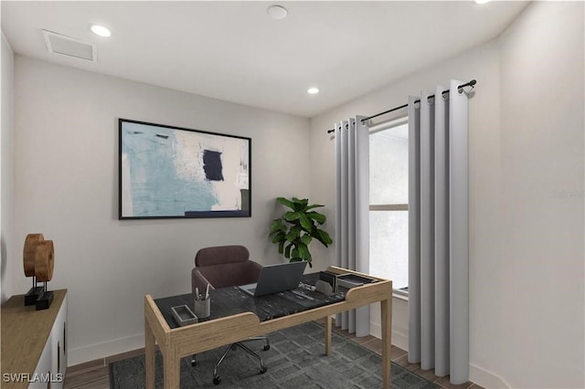 office featuring visible vents, baseboards, wood finished floors, and recessed lighting