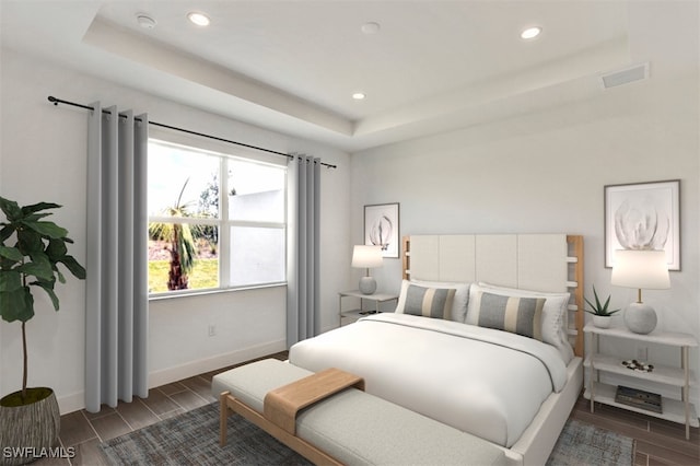 bedroom with visible vents, baseboards, a raised ceiling, and wood finish floors