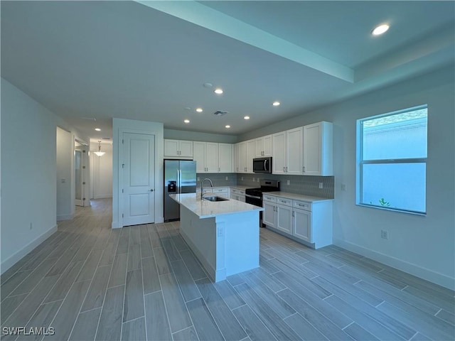 kitchen with white cabinets, range with electric stovetop, stainless steel refrigerator with ice dispenser, and a sink