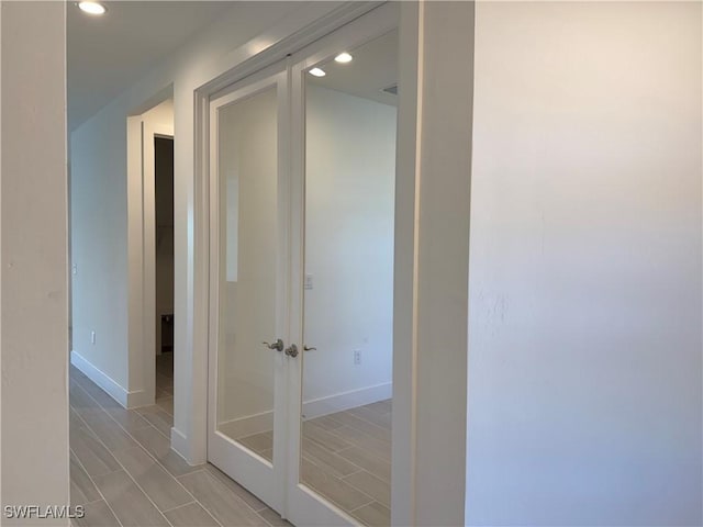 corridor with recessed lighting and baseboards